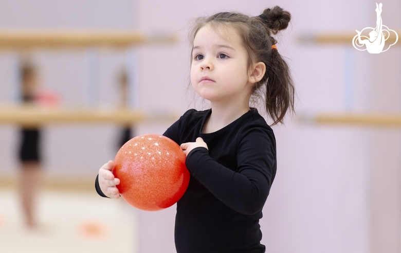 Young gymnast during the ball exercise