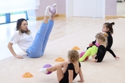 Academy coach Olesya Kovaleva with young gymnasts during training