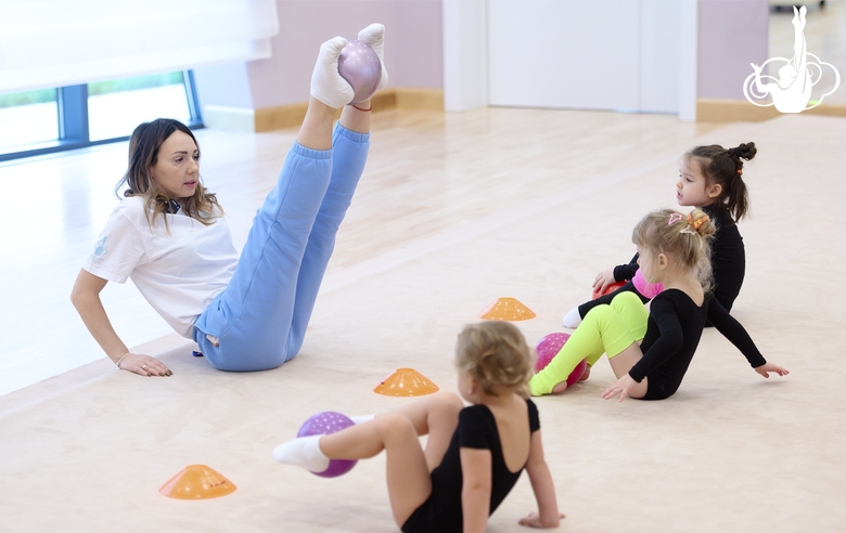 Academy coach Olesya Kovaleva with young gymnasts during training