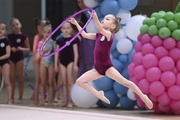 Young gymnast during an exercise with a hoop at the mAlinka tournament