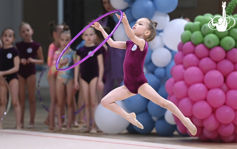 Young gymnast during an exercise with a hoop at the mAlinka tournament