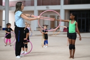 Academy coach Olesya Kovaleva with gymnast Nkenko Sita Davina Chanselvi during the hoop exercise