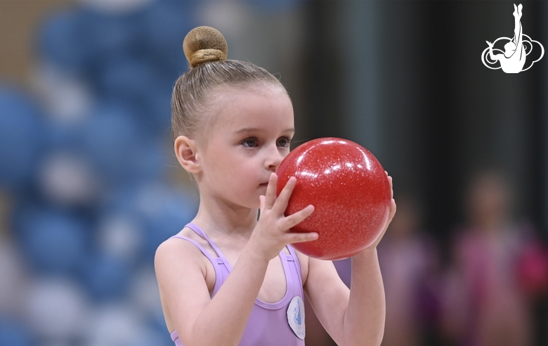 Young gymnast during an exercise with a ball at the mAlinka tournament