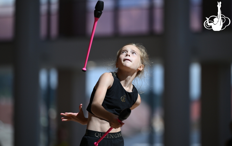 Gymnast during an exercise with clubs