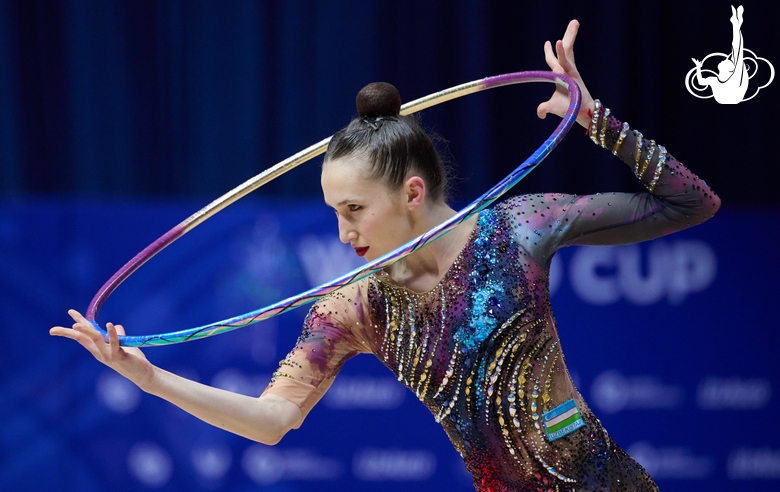 Takhmina Ikromova during an exercise with hoop