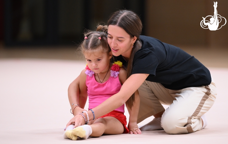 Academy coach Elizaveta Chernova with a young gymnast during the selection