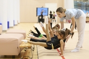 Academy coach Olga Frolova with young gymnasts during a lesson