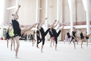 Rhythmic gymnasts  working on choreography elements