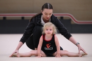 Academy coach with a young gymnast during the selection process