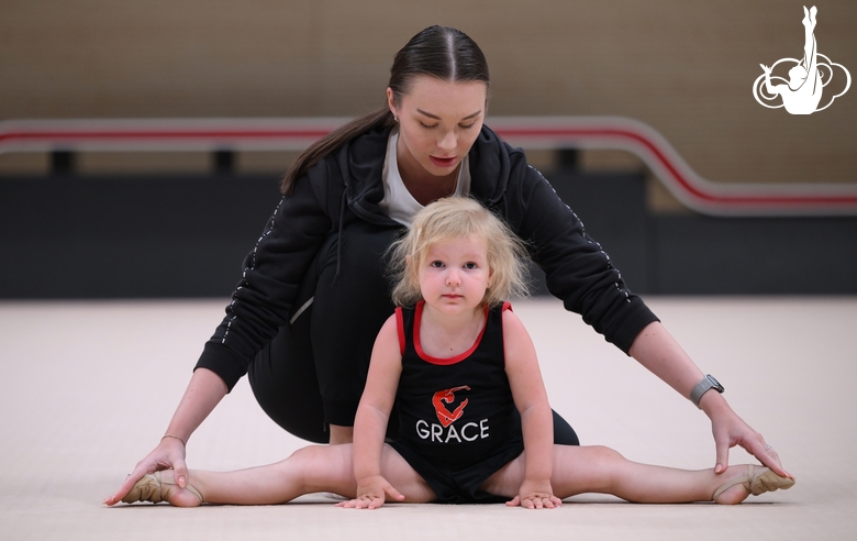 Academy coach with a young gymnast during the selection process