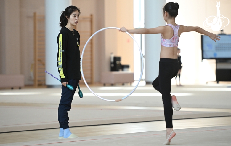 A coach and a gymnast from China during the hoop exercise when training