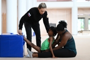 Academy coach Olga Frolova with gymnast Nkenko Sita Davina Chanselvi and coach Dominique Adama from the Republic of Congo during the training session