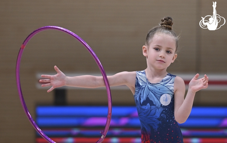 Young gymnast during an exercise with a hoop at the mAlinka tournament