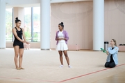 Coaches Pooja Surve and Olga Frolova with gymnast Kimaya Karle