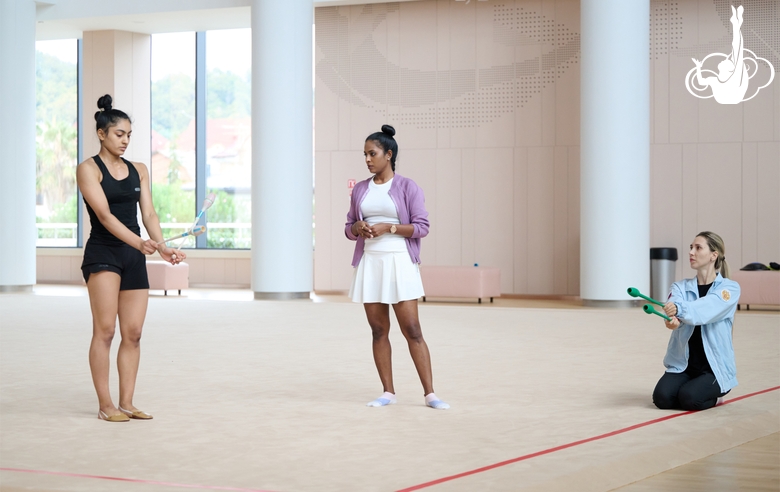 Coaches Pooja Surve and Olga Frolova with gymnast Kimaya Karle