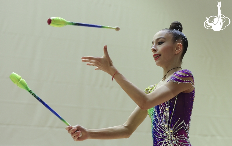 Gymnast during an exercise with clubs