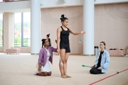 Coaches Pooja Surve and Olga Frolova with gymnast Kimaya Karle