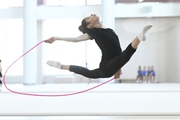 Karolina Tarasova performs a split jump with jump rope during training