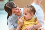 Academy coach Elizaveta Chernova with a young gymnast