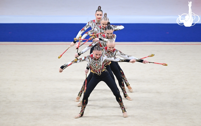 Academy group exercise gymnasts during the exercise with clubs