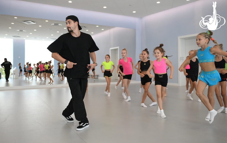 Choreographer Artur Nureev with gymnasts during practice at the training camp in the Academy