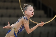 Gymnast does an exercise with a hoop during a solo performance