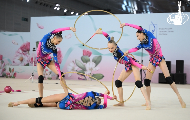 Academy group gymnasts during exercise with hoops