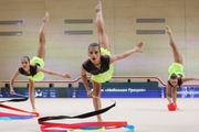 Gymnasts during an exercise with balls and ribbons