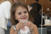 A young gymnast with a gift during the celebration at the Academy