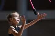 Gymnast during an exercise with clubs