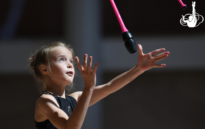 Gymnast during an exercise with clubs