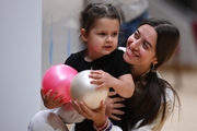 Academy coach Elizaveta Chernova and a young gymnast during a rehearsal