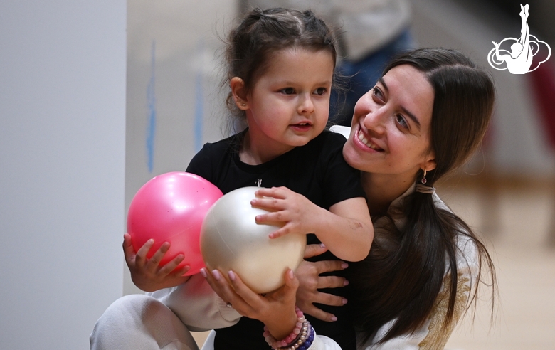 Academy coach Elizaveta Chernova and a young gymnast during a rehearsal