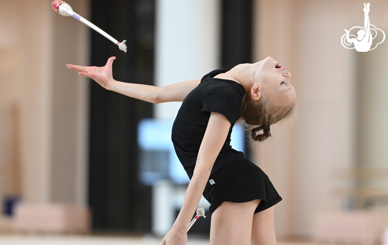 Kristina Voitenkoво during an exercises with clubs