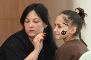 Academy student Valeria Medvedeva in the face painting area