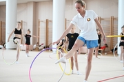 Coach Inna Zhukova and gymnasts during the training session