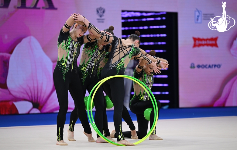 Group team gymnasts from the Omsk region during an exercise with balls and hoops