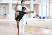 Academy coach Olesya Kovaleva with gymnast Nkenko Sita Davina Chanselvi during the hoop exercise