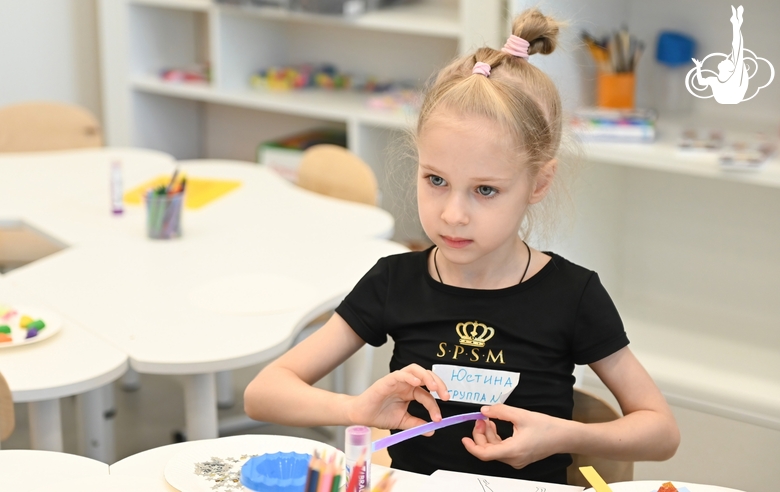 Young gymnast during a lesson in a classroom