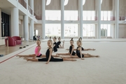 Young gymnasts pose while stretching