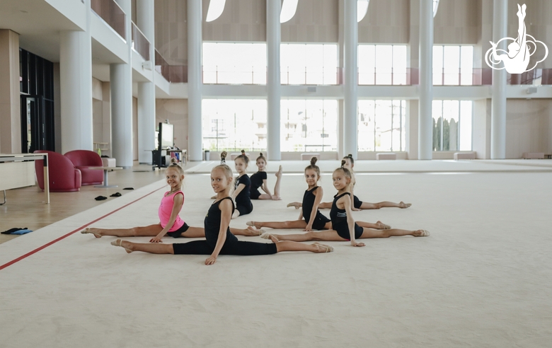 Young gymnasts pose while stretching