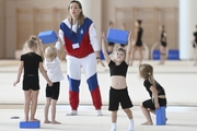 Academy coach Olesya Kovaleva with young gymnasts during training