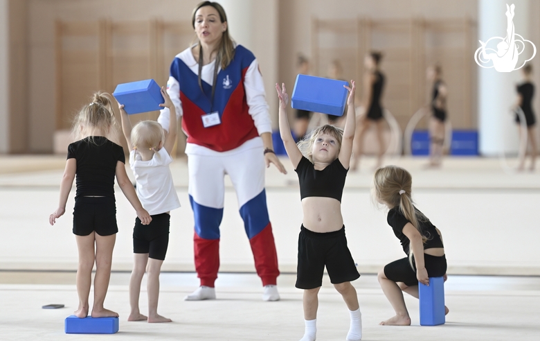 Academy coach Olesya Kovaleva with young gymnasts during training