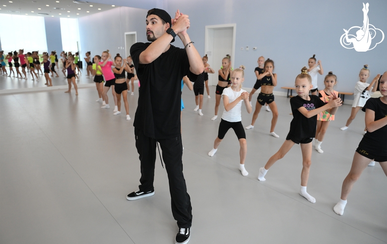 Choreographer Artur Nureev with gymnasts during practice at the training camp in the Academy