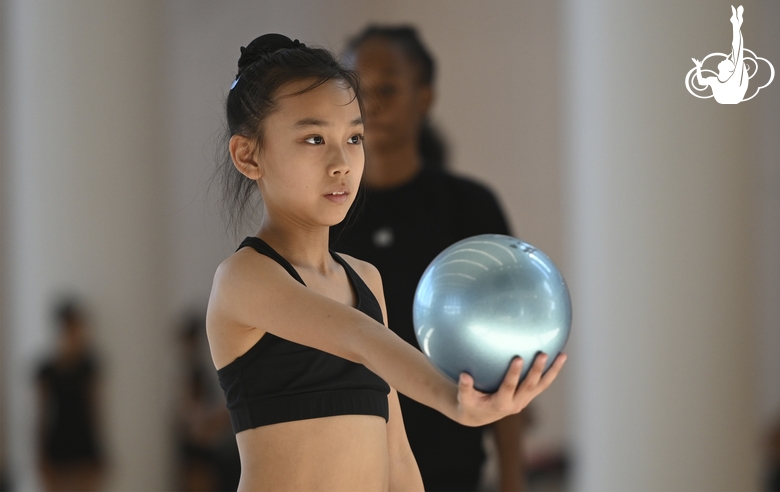 A young gymnast from China during the ball exercise