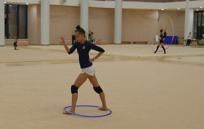 The Olympic champion monitors the training of all the gymnasts in the hall