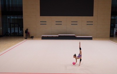 Olympic champion Alina Kabaeva and Russia’s Honored Coach Ekaterina Sergeeva help Elina Khabirova practice her fouetté and jump