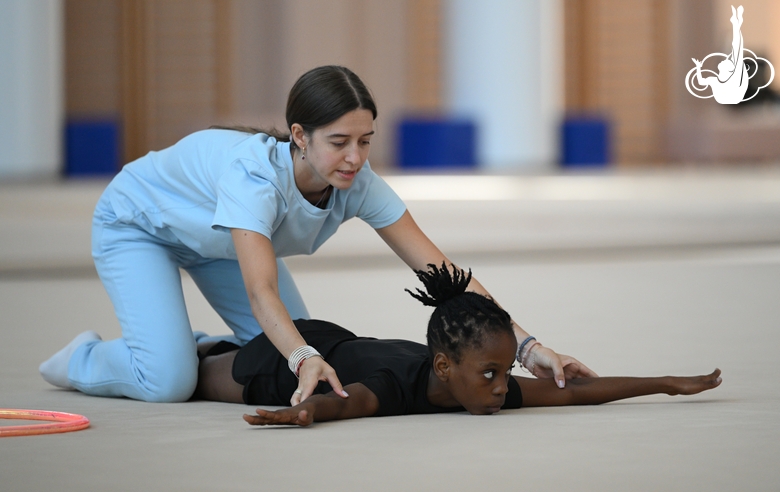 Academy coach Elizaveta Chernova with gymnast Nkenko Sita Davina Chanselvi during the hoop exercise