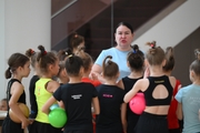 Coach Zlata Tulubaeva with gymnasts during practice at the training camp in the Academy
