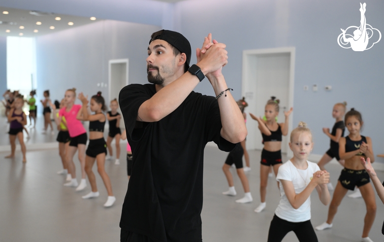 Choreographer Artur Nureev with gymnasts during practice at the training camp in the Academy